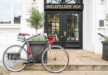 Bicycle parked in front of hotel entrance