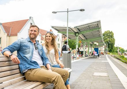 Couple sitting on a bench on the platform
