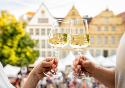 Wine market: two hands holding wine 