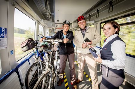 Cyclist with conductor on train