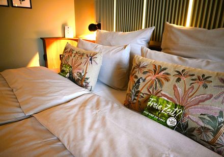 Bed in a hotel room, with a map in front of it