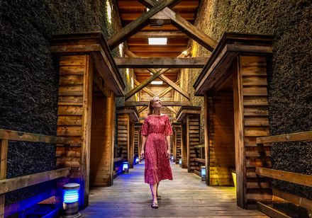 Woman in red dress walking through graduation tower