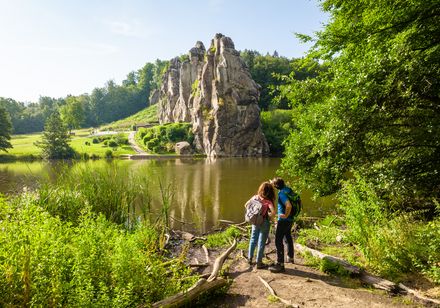 Two hikers looking at the Externsteine rocks
