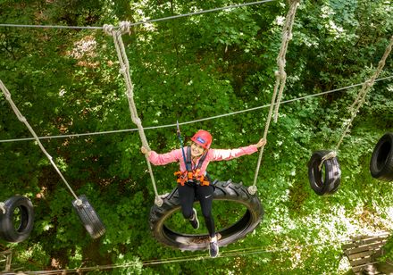 Woman sits on tyres in the climbing park