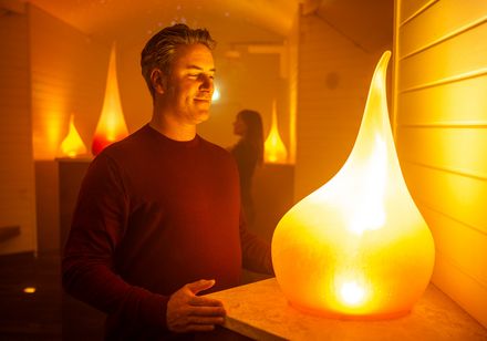 Man standing in warmly lit fog chamber