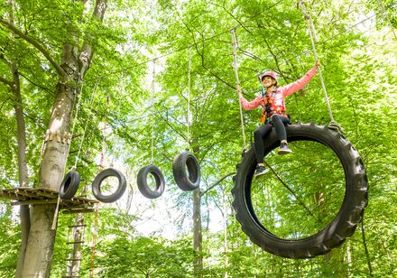 Person climbs on obstacles in climbing park