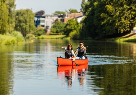 Two people in a red canoe