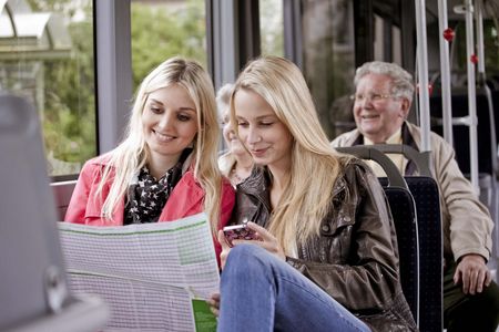 Passengers on the bus read the timetable